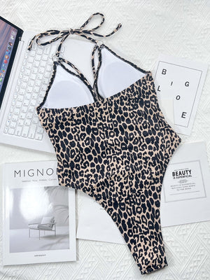 Leopard print one-piece swimsuit with ring detail and halter neck.