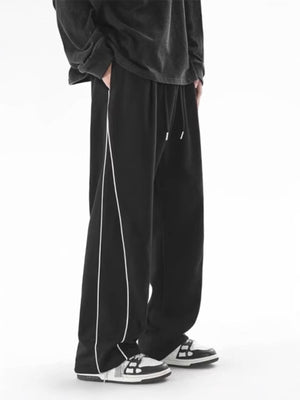 Men's black relaxed fit sweatpants with white side stripes and drawstring waist.
