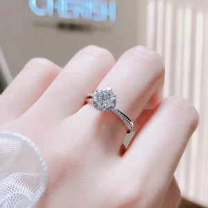 Brilliant moissanite ring in sterling silver with pave band.