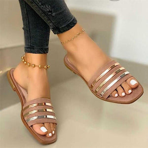Beige open-toe flat sandals with metallic stripes and square toe.