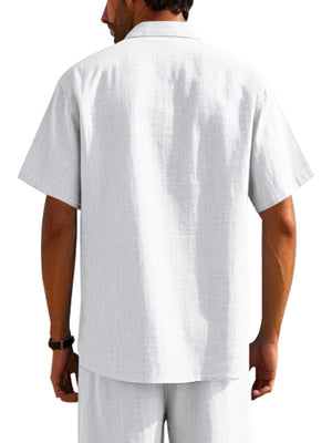 White short sleeve button-down shirt with pockets, collared neckline and breathable fabric.