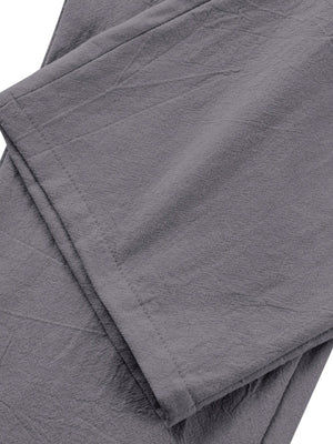 Grey relaxed fit sweatpants with pleated detail and textured fabric.