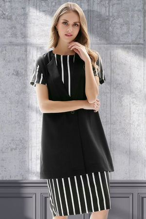 Black sleeveless vest with single button and striped cap sleeves, styled over a striped dress.