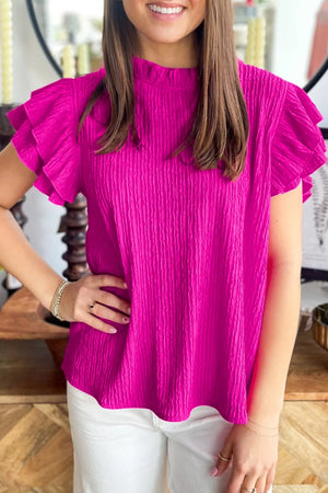 Textured pink mock neck blouse with ruffle sleeves