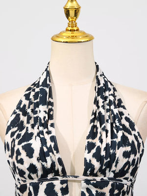 Halter neck leopard print mini dress with a deep V-neck and cutout detail.
