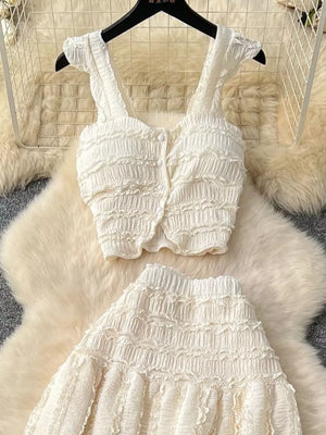White textured two-piece set with ruffled details and buttoned crop top with frill sleeves.