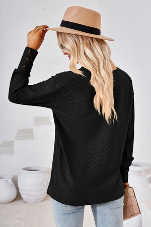 Black textured V-neck blouse with button cuff detail