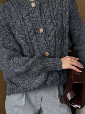 Gray cable-knit button-down cardigan with balloon sleeves and wooden buttons.