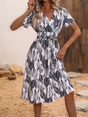 Vibrant Leaf Pattern Midi Dress in blue gray with V-neck, short sleeves, and smocked waist.