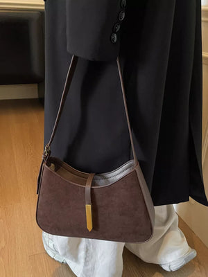 Curved coffee brown suede and leather shoulder bag with gold accent
