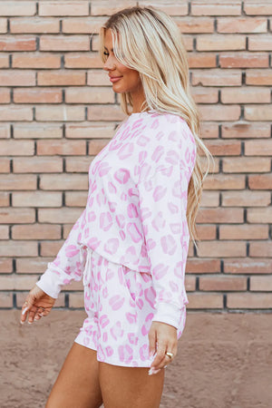 Pink leopard print loungewear set with crew neck sweatshirt and drawstring shorts.