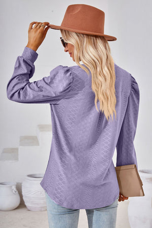 Lavender textured blouse with bishop sleeves and a diamond pattern.