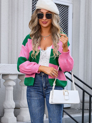Colorblock balloon sleeve knit cardigan in pink and green acrylic with a relaxed fit.
