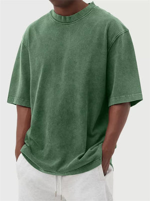 Men's green vintage wash oversized crew neck cotton tee with distressed neckline.