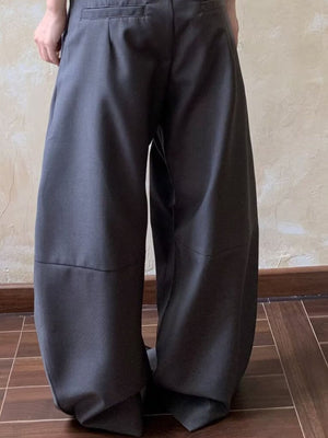 Men's gray wide leg pleated sweatpants with a relaxed fit.