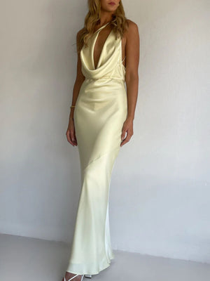 Yellow satin maxi dress with asymmetric halter neckline and body skimming cut.