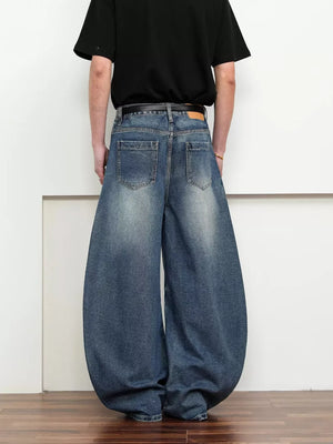 Belted wide leg jeans in dark blue denim with a balloon silhouette.