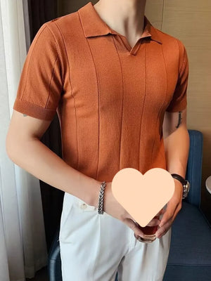 Orange textured knit polo shirt with vertical ribbing and short sleeves.