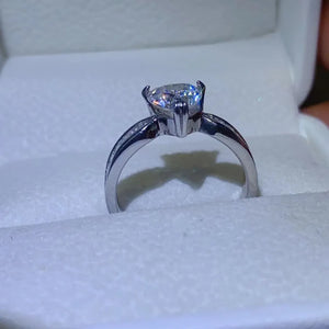 Silver ring with heart-cut moissanite and baguette accents