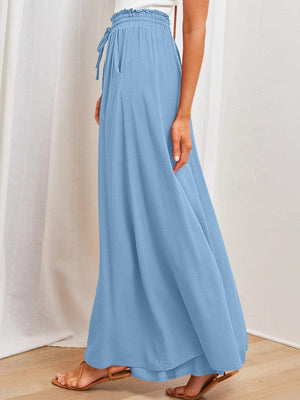 Light blue textured drawstring palazzo trousers with pockets and wide legs.