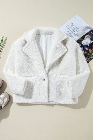 White teddy bear collarless jacket with lapels and a single clasp closure.