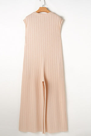 Textured ribbed sleeveless collar jumpsuit in eggshell with wide leg and side slit.