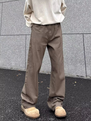 Brown wide-leg sweatpants with pockets, styled with a cream sweatshirt and tan clogs.