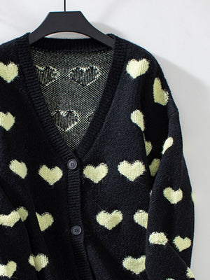 Black jacquard knit cardigan with allover heart pattern and button front.