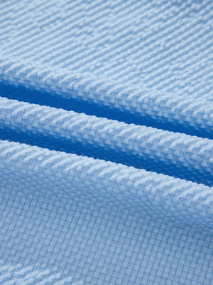 Light blue seersucker fabric detail on a relaxed fit blouse.