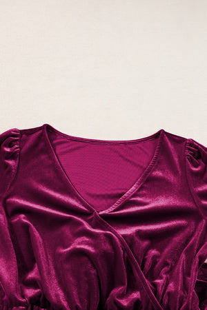 Burgundy velvet wrap romper with V-neck and ruffled cap sleeves.