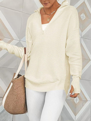 Cream ribbed knit funnel neck pullover sweater with quarter zip and thumbholes.