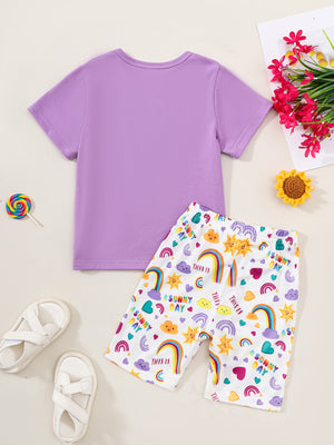 Girls' purple graphic tee and rainbow print shorts set.