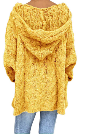 Yellow cable knit hooded cocoon sweater with chunky knit texture.