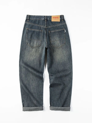 Vintage wash blue cotton denim loose fit jeans with a rolled hem.