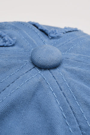 Cobalt blue denim baseball cap with raw edge detail and button top