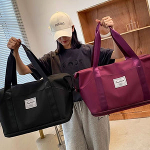 Large capacity travel duffel bags in black and deep purple with white "Fashion" labels.