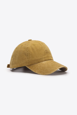 Washed cotton baseball cap in mustard with adjustable strap detail.