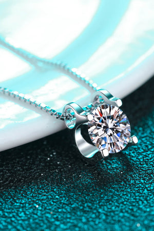 Sterling silver pendant necklace with a solitaire moissanite diamond on a delicate chain.
