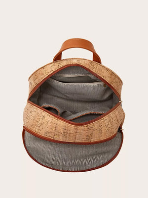 Cork backpack with brown trim and chevron lining, open to show interior pockets.