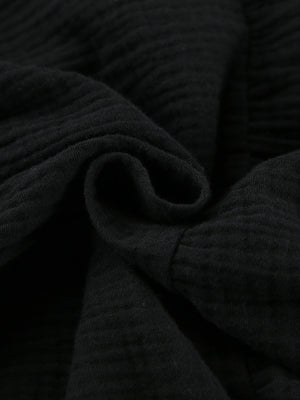 Black cotton tiered mini dress with textured fabric detail