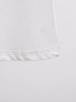 White midi dress detail showing hem and stitching