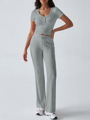 Light gray button-front crop top and flared lounge pants with drawstring waist.