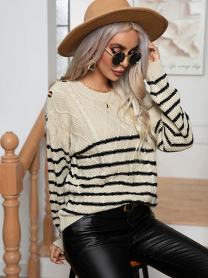 Beige cable-knit sweater with black stripes and shoulder buttons