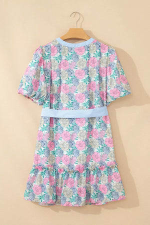 Floral mini dress with puff sleeves, contrast trim, and belted waist.