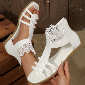 White lace-trimmed gladiator sandals with braided straps and back zipper detail.
