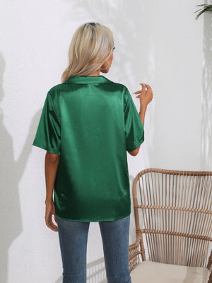 Emerald satin collared shirt with short sleeves, shown from the back.
