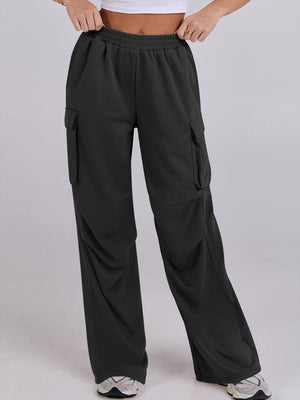Black sweatpants with cargo pockets and a wide leg, featuring a comfortable elastic waistband.