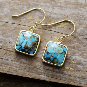 Turquoise matrix square drop earrings with gold hooks.