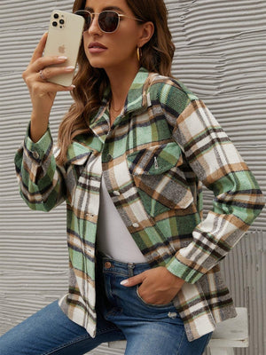 Green plaid collared long sleeve jacket with buttoned chest pockets and cuffs.