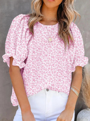 Pink floral print maternity blouse with smocked bodice and ruffle sleeves.